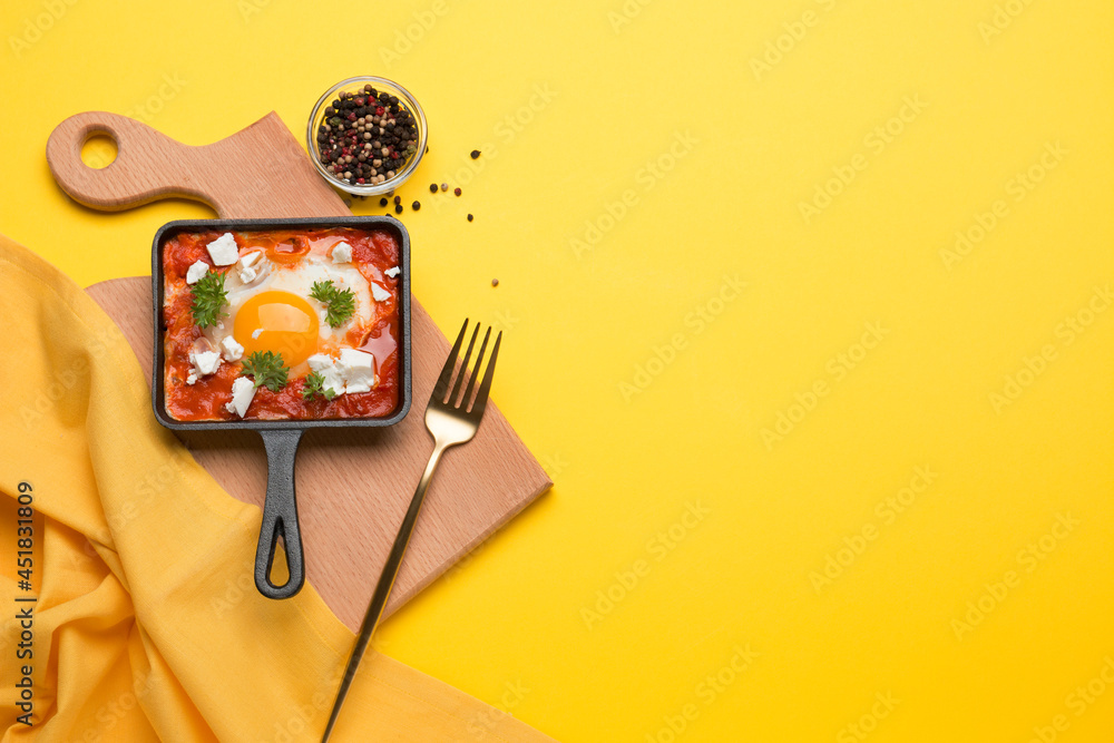 Fried eggs with tomatoes and cheese in a frying pan. Shakshuka, a Jewish dish.
Fried eggs with tomatoes and cheese in a frying pan. Shakshuka, a Jewish dish.