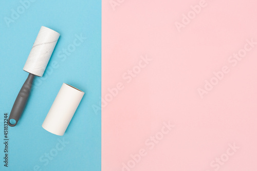 The cleaning roller. Sticky Lint Roller Set. Blue and pink background. Copy space. Place for text. Top view.