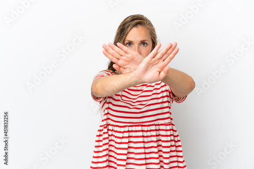 Young caucasian woman isolated on white background making stop gesture with her hand to stop an act