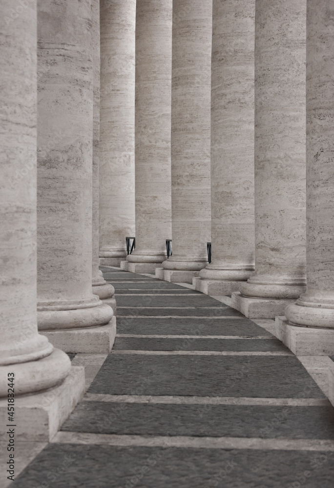 The row of round stone columns. Passage between columns. Stock Photo
