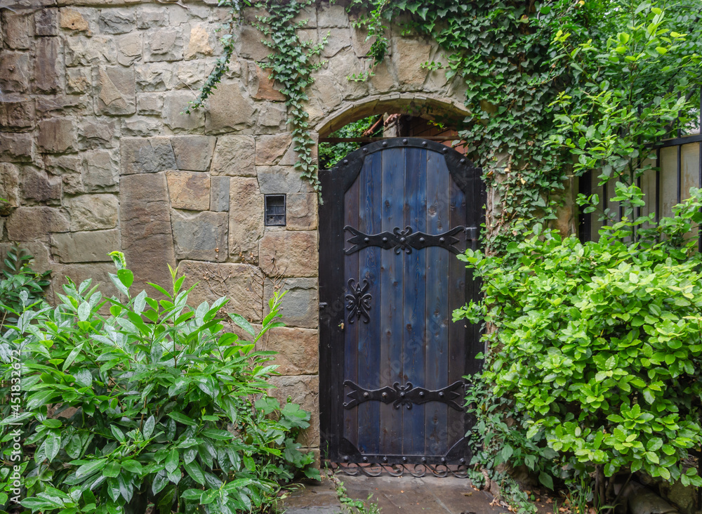 An old wooden door in a stone wall. An old wooden door in a stone wall.