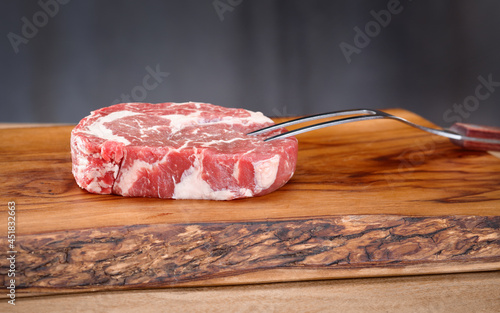 raw meat on wooden board