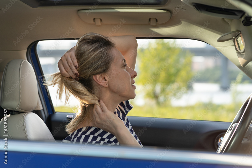 Bored woman drive car look in mirror playing with hair and hairstyle while waiting in traffic jam. Adult vehicle owner, female driver distract from road. Safe steering and transportation concept Bored woman drive car look in mirror playing with hair and hairstyle while waiting in traffic jam. Adult vehicle owner, female driver distract from road. Safe steering and transportation concept