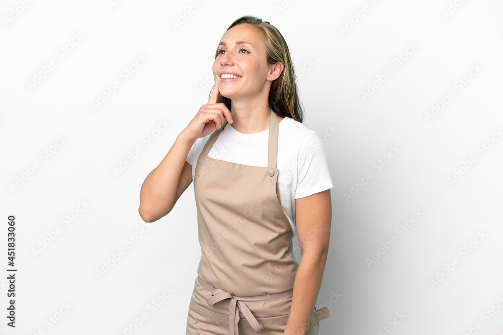 Restaurant waiter caucasian woman isolated on white background thinking an idea while looking up Restaurant waiter caucasian woman isolated on white background thinking an idea while looking up