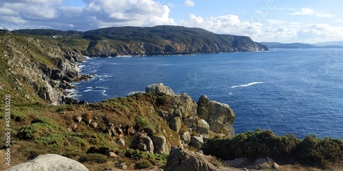 The sea penetrates into a bay seen from the top of a granite cliff on the Spanish Cantabrian coast