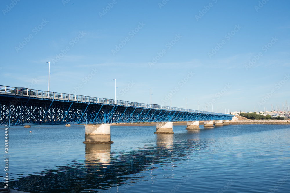 Beautiful old blue bridge over Arade river at Portimao. Cars crossing, Portugal, Europe