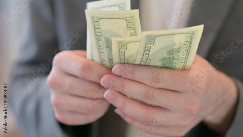 Close up of Male Hands Counting Dollars