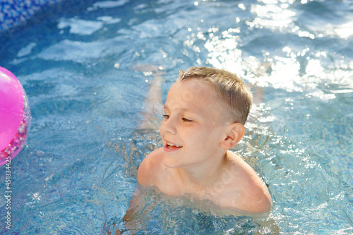 child playing in the pool. Summer. Refreshing procedure. Water background 