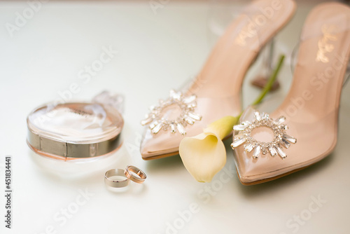 wedding gold rings next to the bride's shoes