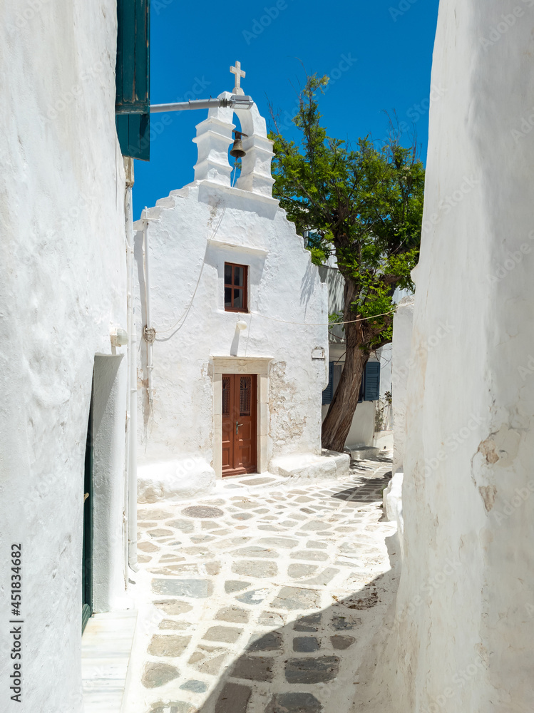Whitewashed Greek Orthodox Christian Church at Mykonos island Cyclades destination Greece. Vertical