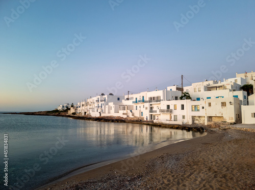 Paros island, Greece, Cyclades. Naousa city panoramic view, advertisement. Sandy beach calm sea.