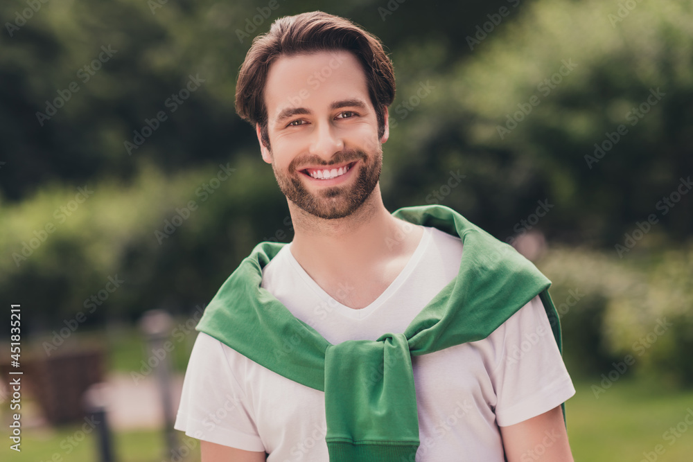 Photo of young handsome cheerful man happy positive toothy smile walk park green trees nature summer outdoors