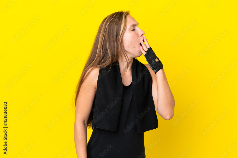 Young sport English woman isolated on white background yawning and covering wide open mouth with hand Young sport English woman isolated on white background yawning and covering wide open mouth with hand