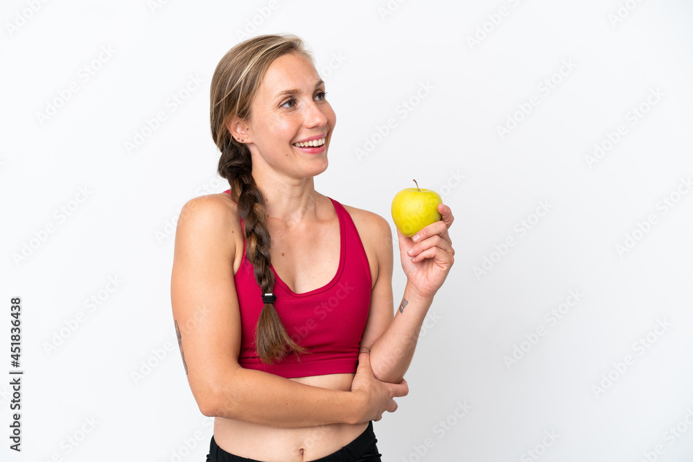 Young English woman isolated on white background with an apple and happy Young English woman isolated on white background with an apple and happy