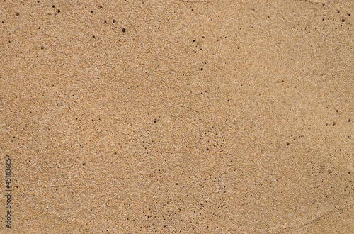Sand texture background. Sand on the beach after a wave