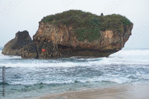 Mesra beach with a natural background. Mesra means intimate. Mesra beach also known as kukup beach or ngrawe beach photo