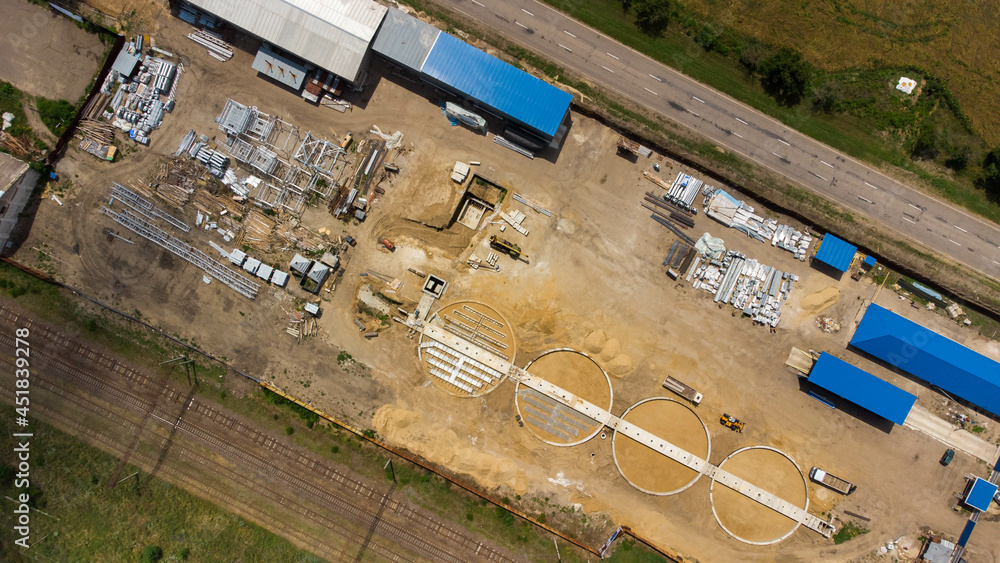 Aerial view of modern grain elevator. Wheat storage building, building in progress. Silo farm. Agribusiness development construction. Aerial view of modern grain elevator. Wheat storage building, building in progress. Silo farm. Agribusiness development construction.