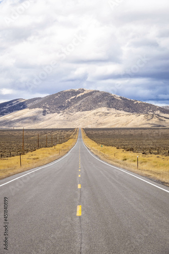 A long, straight road heading into the distant mountains