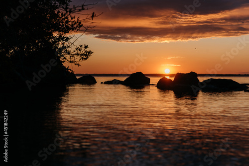 Photo of a Summer Sunset on the Lake. Travel location of popular tourist outdoor. View of beautiful Sea Landscape. Relax vacation near water