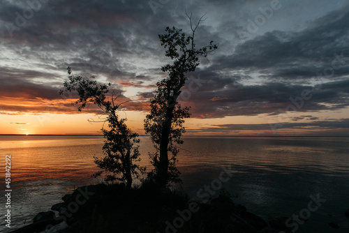 Photo of a Summer Sunset on the Lake. Travel location of popular tourist outdoor. View of beautiful Sea Landscape. Relax vacation near water
