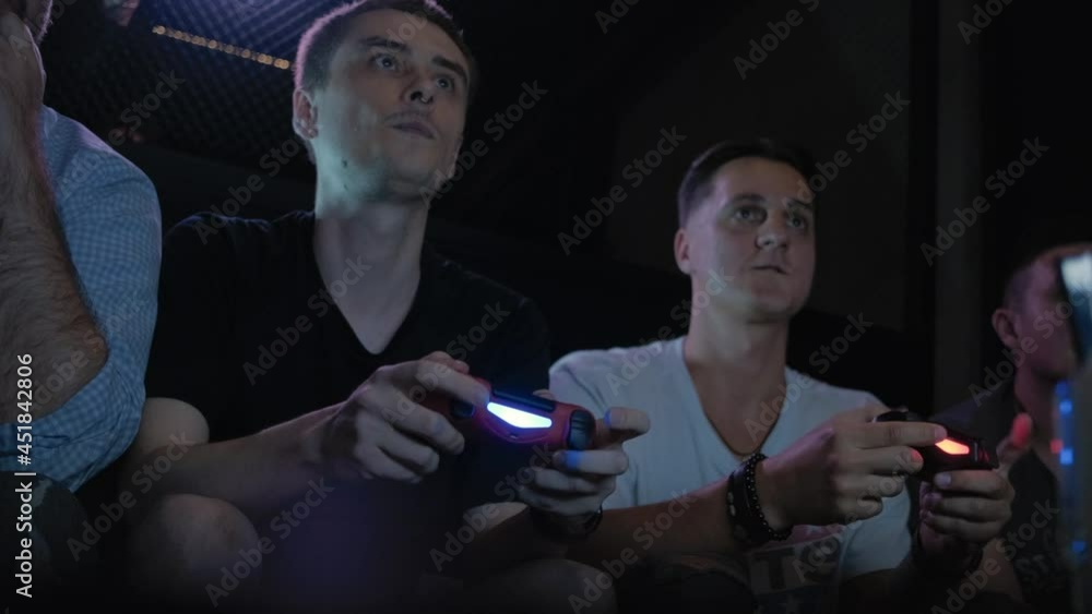 a bearded guy plays with friends in a game console a bearded guy plays with friends in a game console