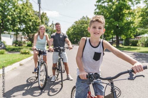 Young family on country bike ride on the summer season