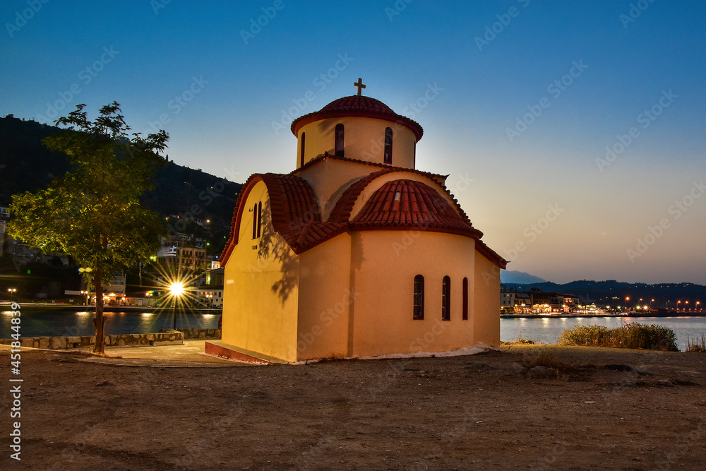 A chapel and a night panorama of the town of Gythio, Greece 