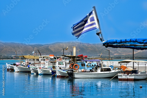 white boats in the Greek gulf, the flag of Greec