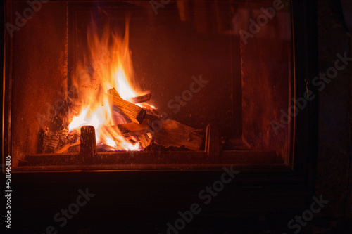 dark fireplace with burning wood