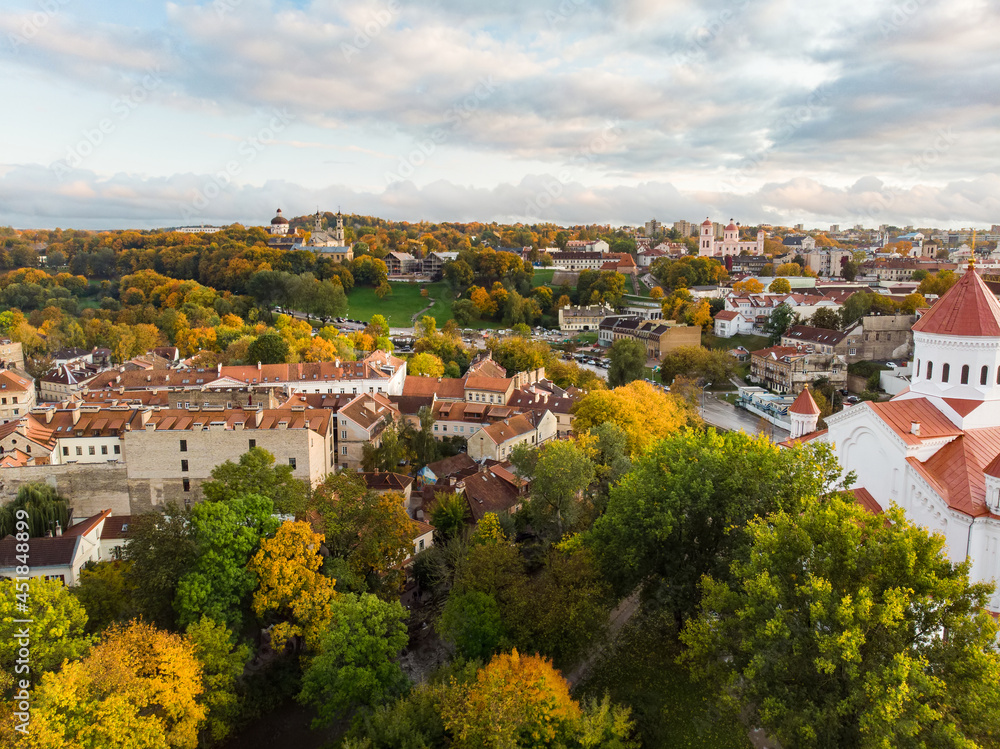 Beautiful Vilnius city panorama in autumn with orange and yellow foliage. Aerial evening view. Fall city scenery in Lithuania