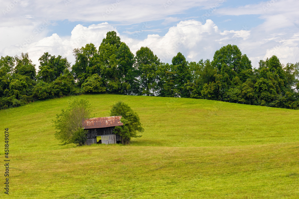 Decaying outbuilding on a hillside under cloudy skies in rural Virginia Decaying outbuilding on a hillside under cloudy skies in rural Virginia