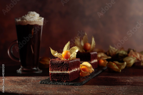 Chocolate cake with physalis on a brown background.