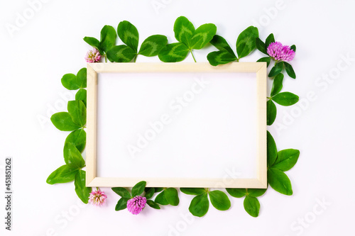 White paper frame text. Flat surface, white background. With clover petals