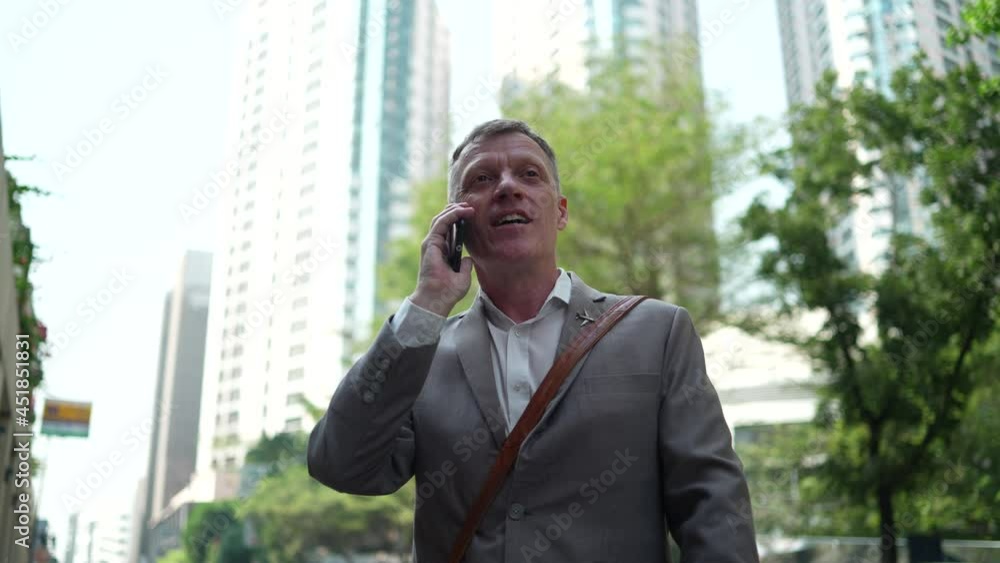 businessman with smartphone, using mobile phone to call with business partner in background of city urban, lifestyle with digital communication technology, walking at outdoor street of downtown city businessman with smartphone, using mobile phone to call with business partner in background of city urban, lifestyle with digital communication technology, walking at outdoor street of downtown city
