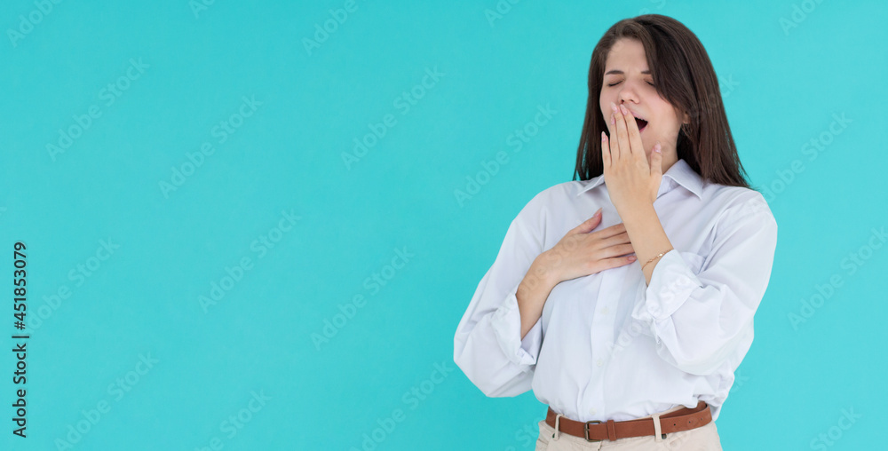 Tired woman yawning covering open mouth with hand need rest. Young female worker being sleepy head can't wake up having insomnia. Chain reaction Tired woman yawning covering open mouth with hand need rest. Young female worker being sleepy head can't wake up having insomnia. Chain reaction