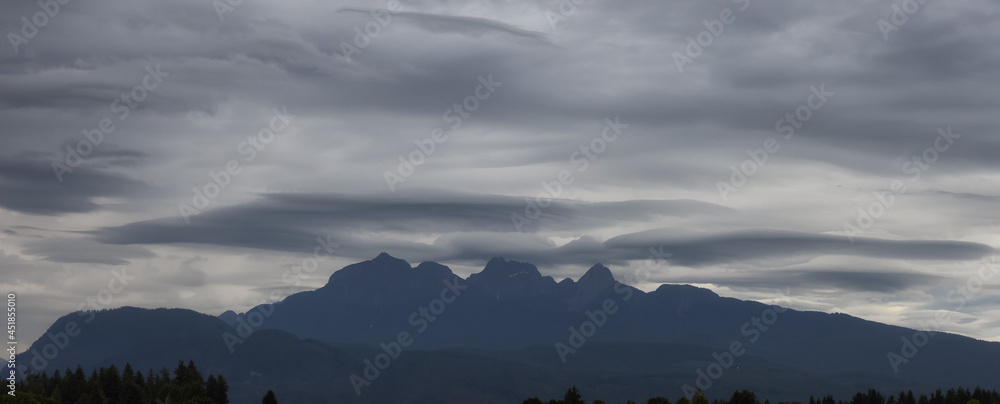 Golden Ears Mountain Peaks during dramatic cloudy sunset. Canadian Nature Landscape. Pitt Meadows, Vancouver, British Columbia, Canada. Nature Background Panorama