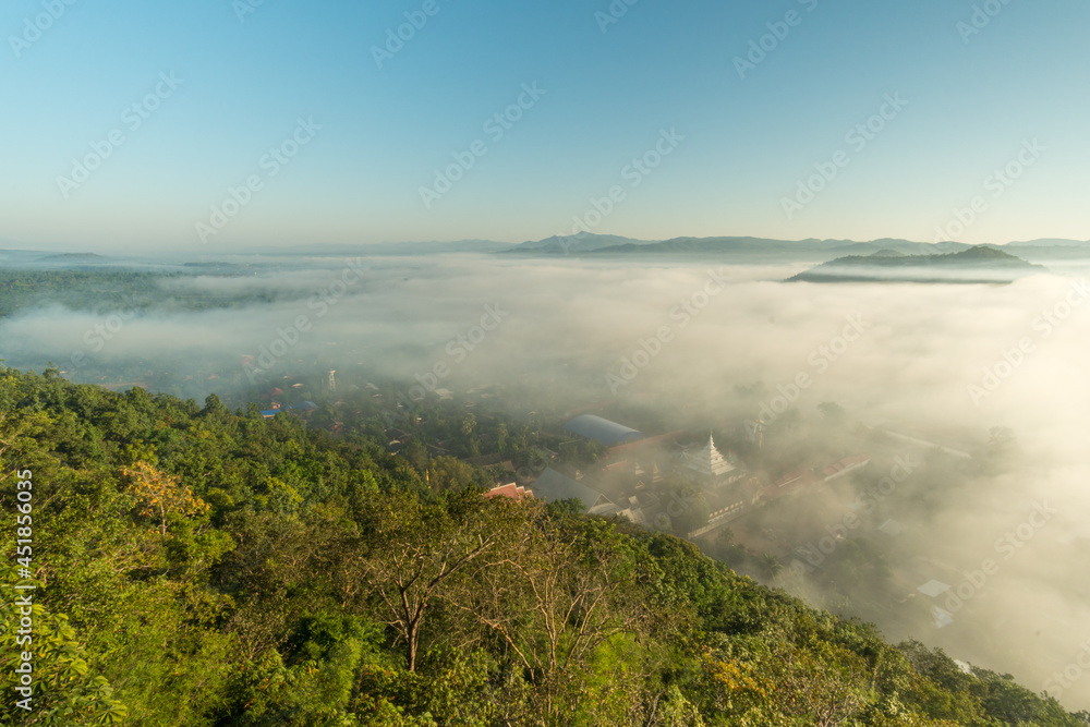 Morning fog covers Lamphun, Thailand, view from the viewpoint of Wat Phra That Pha Temple