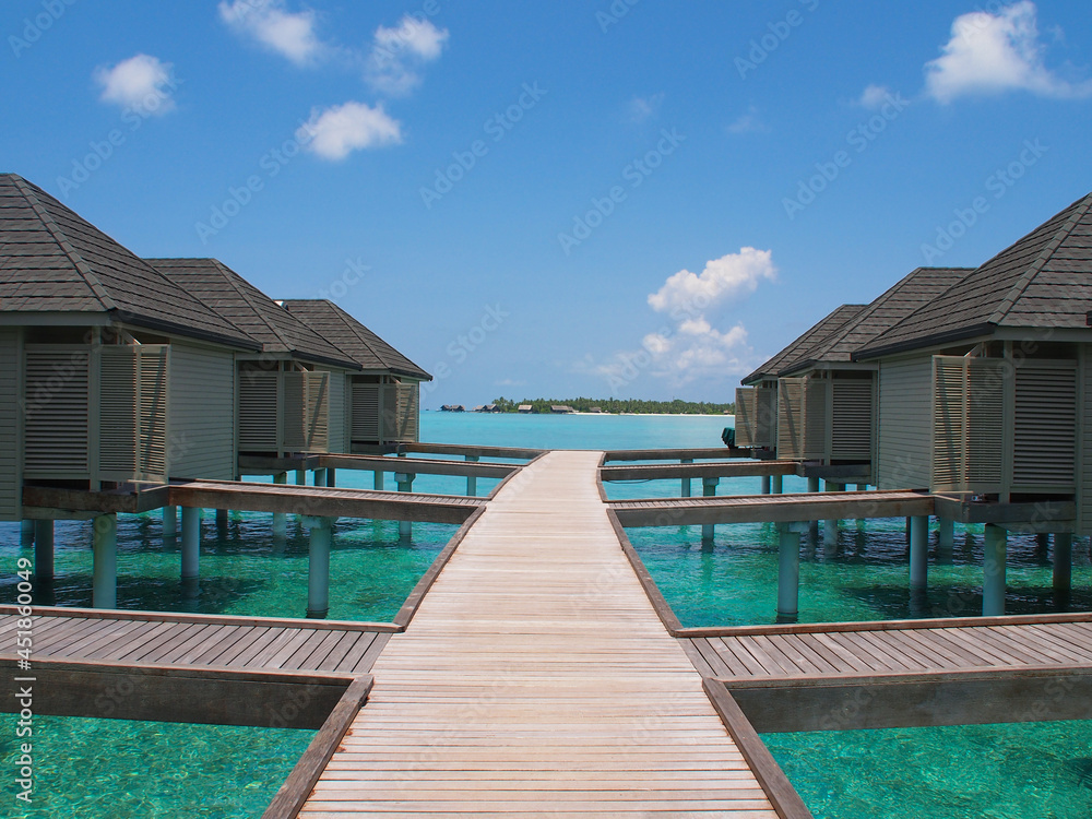 Wooden bungalow on the coast of the Maldives on a sunny day. Copy space for text.