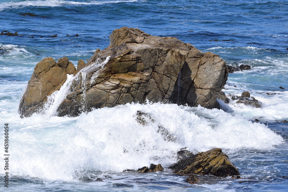 Ocean waves splashing onto some rocks at 17 Mile Drive in Monterey, California. Ocean waves splashing onto some rocks at 17 Mile Drive in Monterey, California.