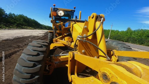 Grader is leveling ground, working at construction of new road, onboard camera
