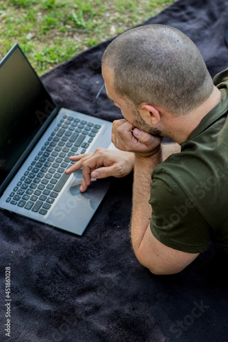 Close up of a caucasian male typing on his laptop.