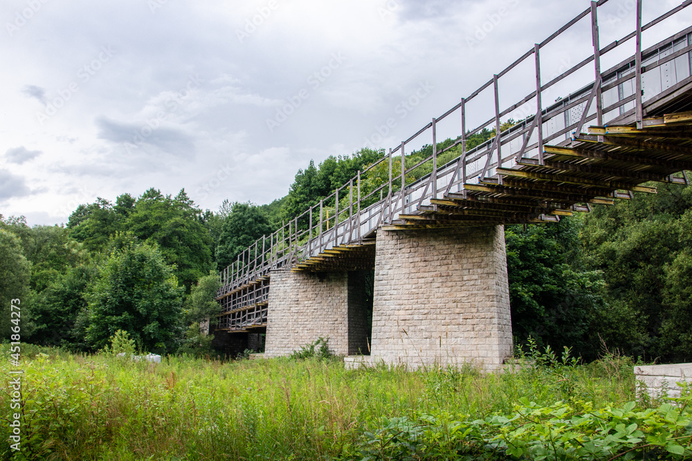 old steel column viaduct surrounded by trees old steel column viaduct surrounded by trees