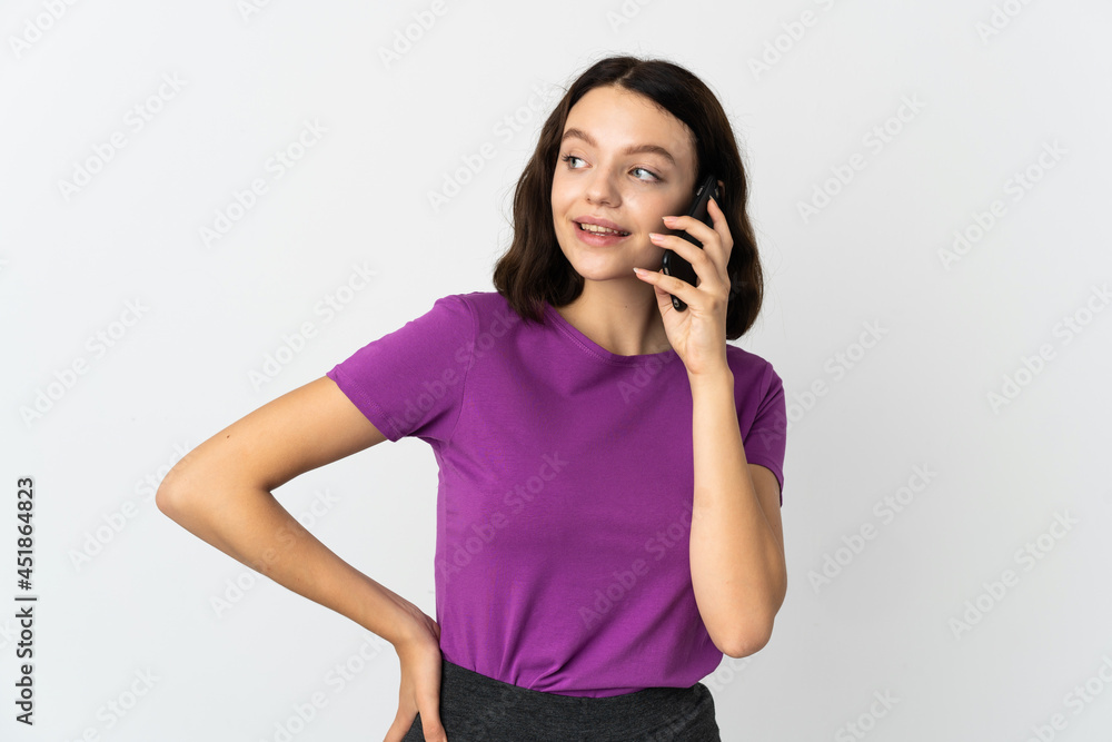 Teenager Ukrainian girl isolated on white background keeping a conversation with the mobile phone with someone Teenager Ukrainian girl isolated on white background keeping a conversation with the mobile phone with someone