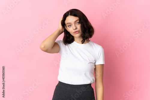 Teenager Ukrainian girl isolated on pink background with an expression of frustration and not understanding