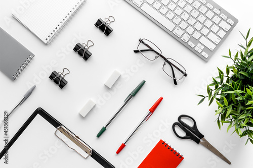 Trendy white office desk table with computer keyboard. Top view