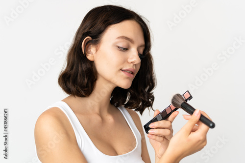 Teenager Ukrainian girl isolated on white background with makeup palette