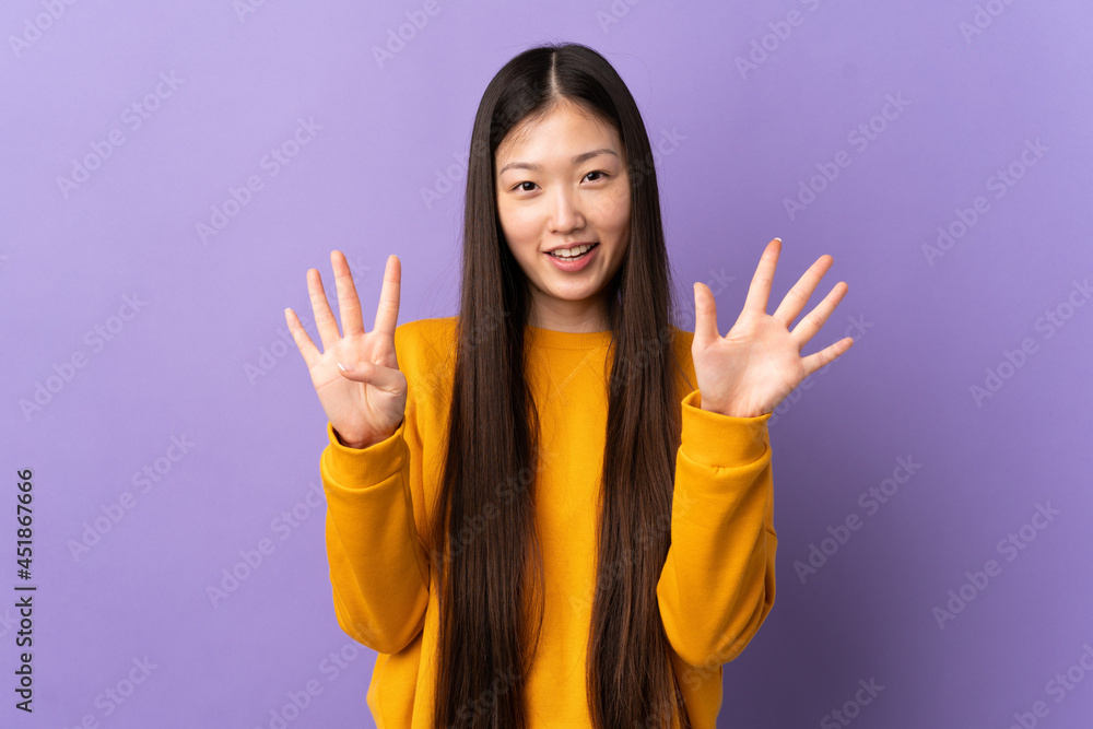 Young Chinese girl over isolated purple background counting nine with fingers Young Chinese girl over isolated purple background counting nine with fingers