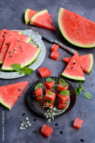 Vertical view of a gray table with slices of ripe watermelon. Still life