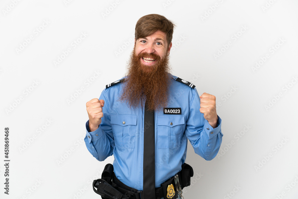 Redhead police man isolated on white background celebrating a victory in winner position Redhead police man isolated on white background celebrating a victory in winner position