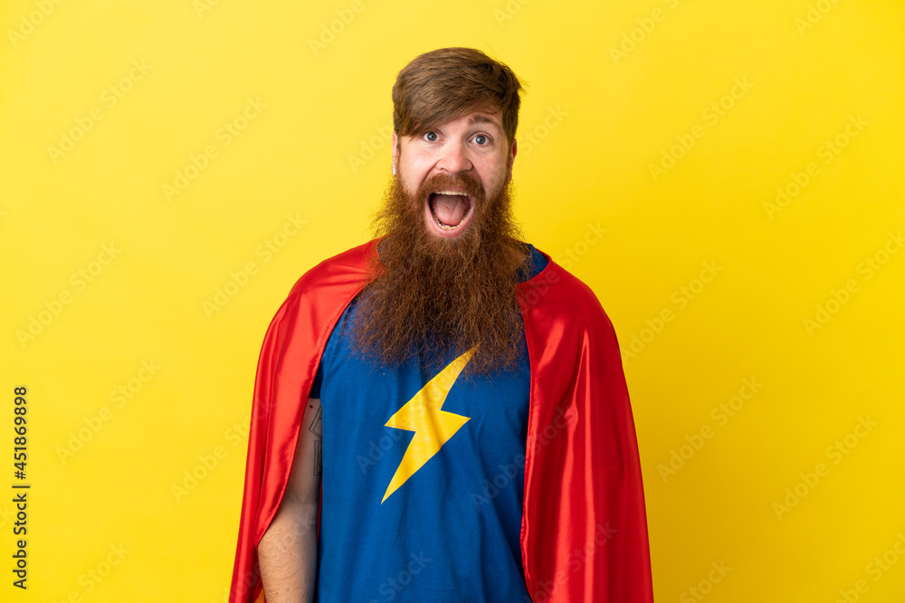 Redhead Super Hero man isolated on yellow background with surprise facial expression Redhead Super Hero man isolated on yellow background with surprise facial expression